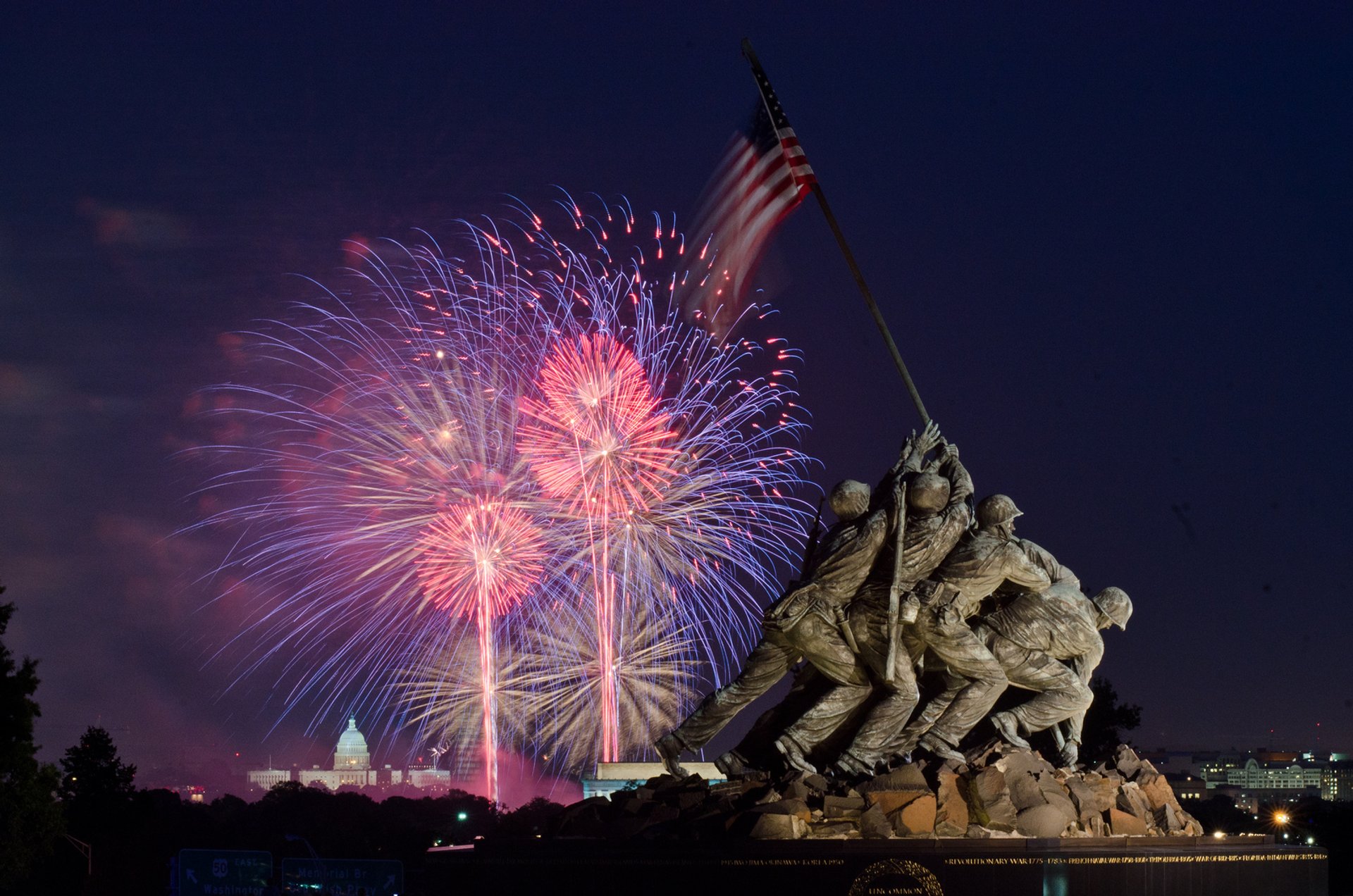 Marine Corps Iwo Jima flag raising monument in Washington D.C. at night with fireworks in background